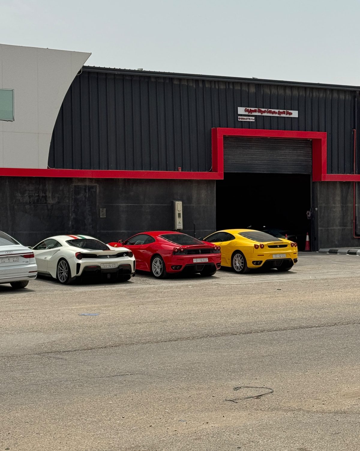 Ferrari 488 Pista, F430 and a yellow F430 at the Seven Motors entrance